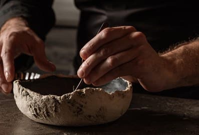 Chef plating a gourmet dish at Smoked Room restaurant