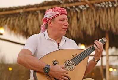 Hans Zimmer playing a local instrument in Dubai