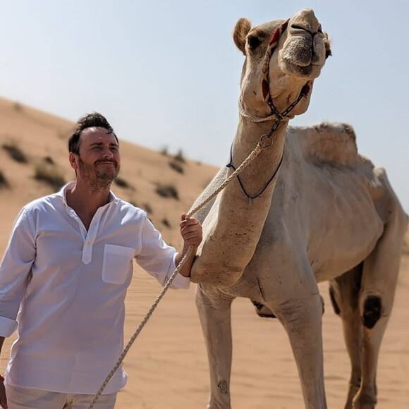 Jason Atherton with a camel in the Dubai Desert