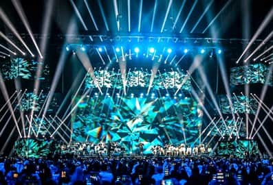 Live entertainment performance with dramatic lighting at an indoor arena
