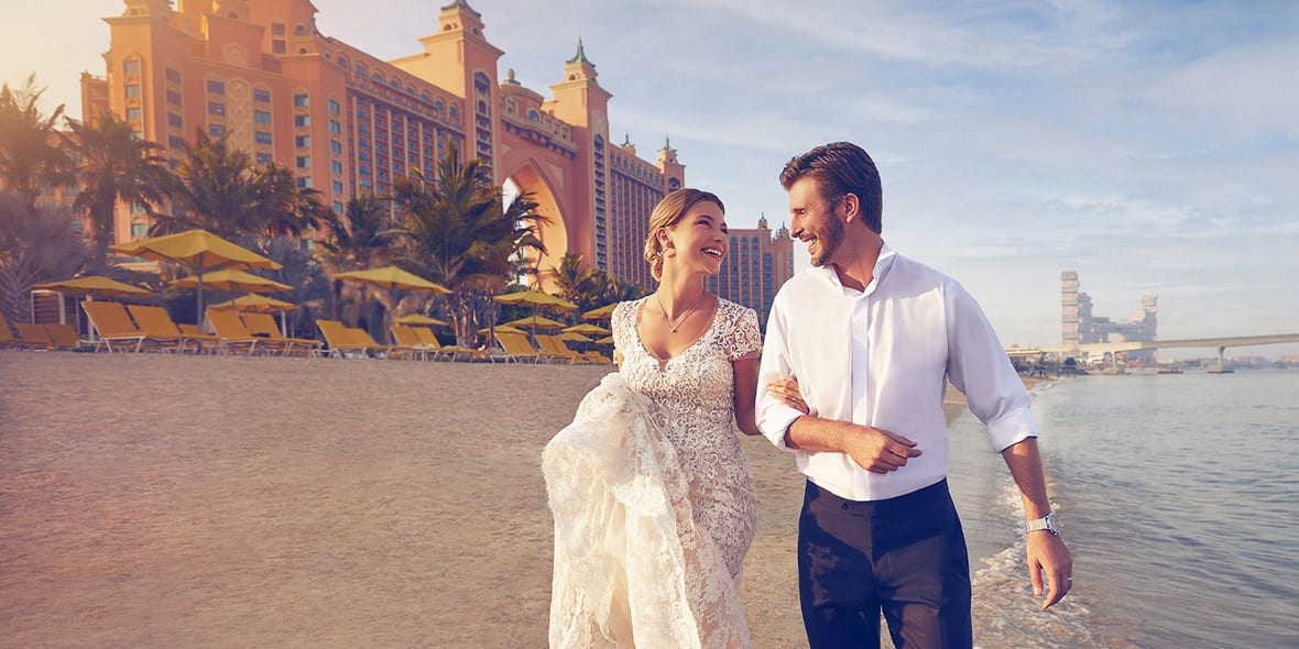 Couple walking on the beach Atlantis Dubai