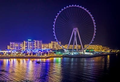 Lighten Ain Dubai at night, taken from JBR side with reflections in the water