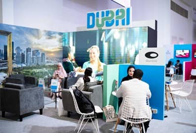Visitors exploring exhibition stands at a Dubai business event