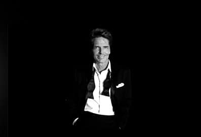 Richard Marx portrait in a suit within bowtie undone in black in white
