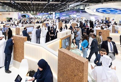 Visitors exploring property exhibitions and meeting exhibitors at a real estate event