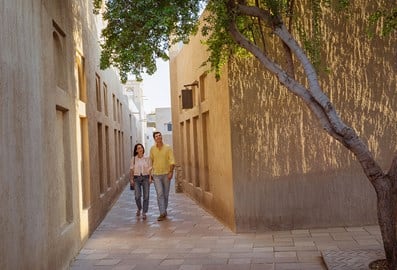 A couple walking through the Al Fahidi Historical Neighborhood