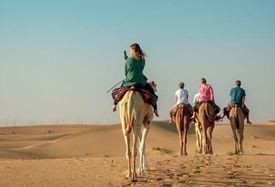 Arabian desert camel riding center group