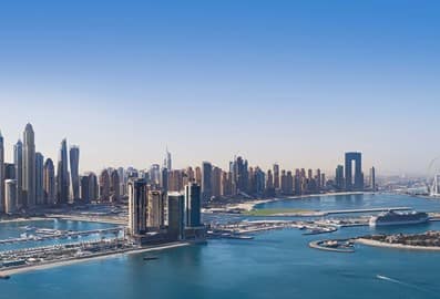 Wide panoramic aerial view of the Dubai Marina skyline and sunny coastline