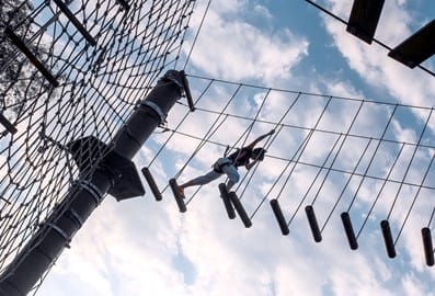 A kid on a climbing frame at Aventura Park.