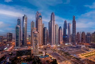 Dubai Marina skyline with high-rise towers illuminated at dusk
