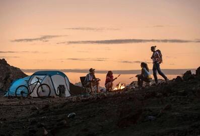 People at a camping spot in Hatta during sunset.