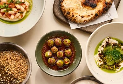 Mediterranean-style shared small plates table spread at LOWE restaurant