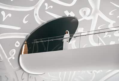 An Emirati man standing in the top passage area inside the Museum of the Future