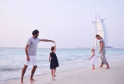 Family at Sunset Beach in Dubai with Burj Al Arab in the background