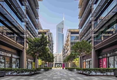 25 Jump Street alley between buildings with one of the Emirates Towers showing in the background and clear blue skies