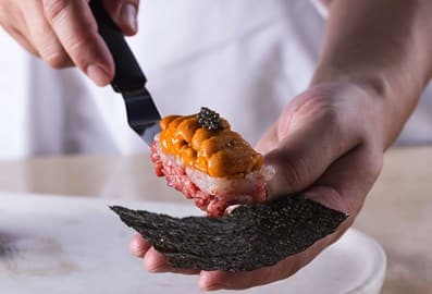 Beef and sea urchin temakizushi handroll served on a ceramic plate at Ken by Kamatsuda restaurant