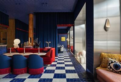 The striking blue and red interior design of OTHER restaurant in Dubai