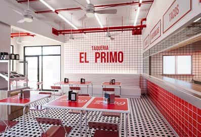 The vibrant red and white dining interior of Taqueria El Primo restaurant