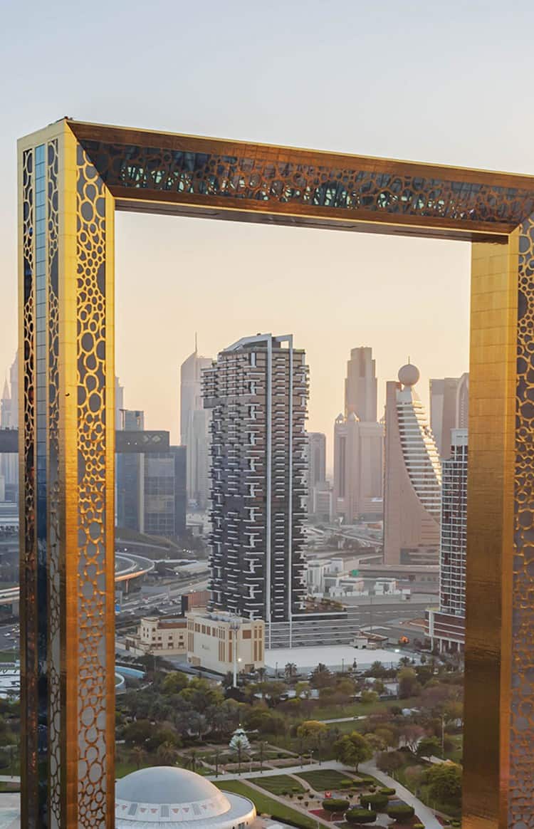 Aerial view of Dubai Frame with Dubai’s skyline and landscaped park surrounding it