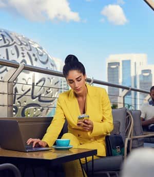 25 Hour Hotel outdoor view of Museum of the future | Female investors working on the laptop