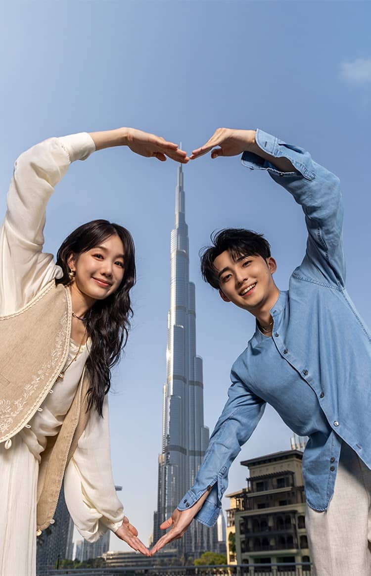 A couple posing in front of Burj Khalifa
