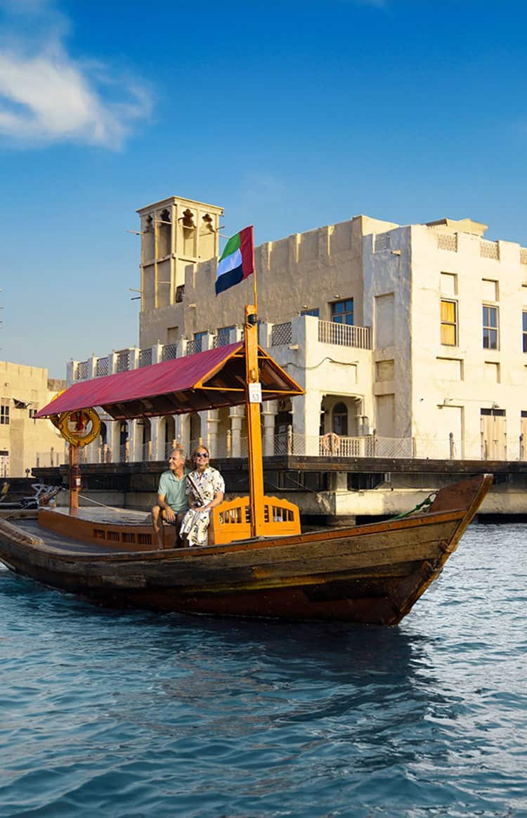 An elderly couple enjoying a boat trip on the Dubai Creek.