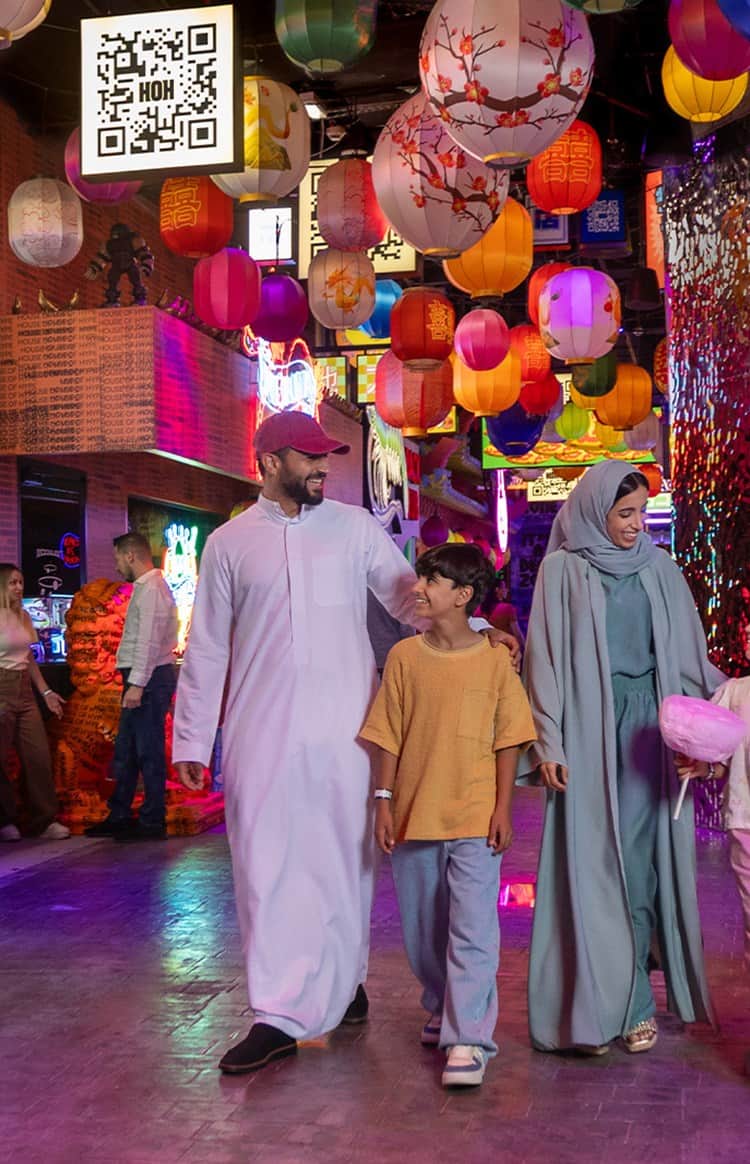 GCC family walking together through a colorful immersive space