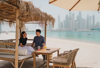 beach couple dubai skyline arabian gulf