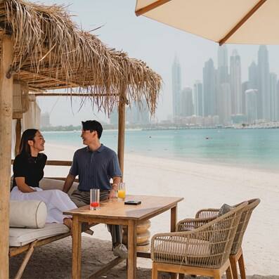 beach couple dubai skyline arabian gulf