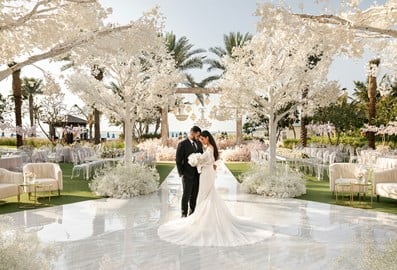 Outdoor wedding ceremony by the beach with married couple standing on the dancefloor