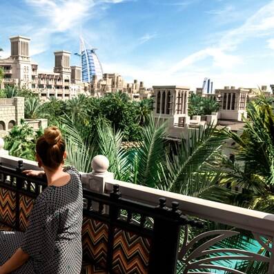 Woman overlooking Madinat Jumeirah with Burj Al Arab in the background