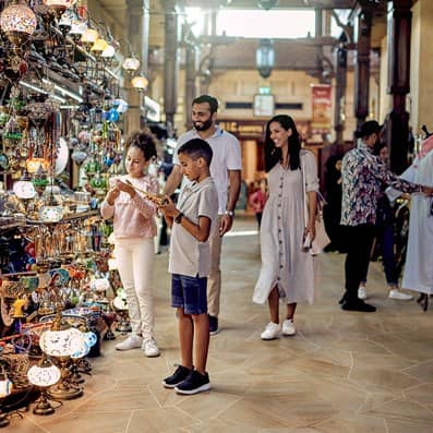 Family at Souk Madinat in Jumeirah shopping for mementos