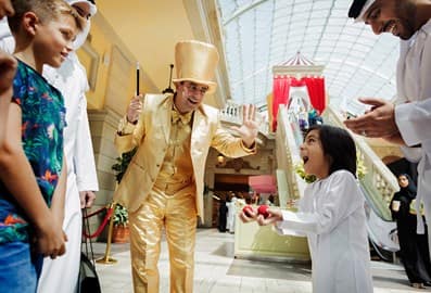 Child amazed with performers at Mercato Mall