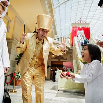 Child amazed with performers at Mercato Mall