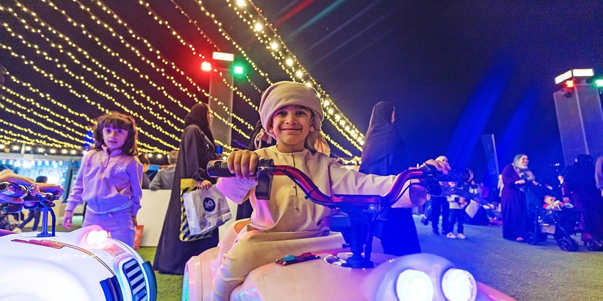 Emirati kid riding a bike outdoors