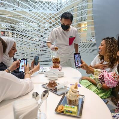 Women taking pictures of desserts