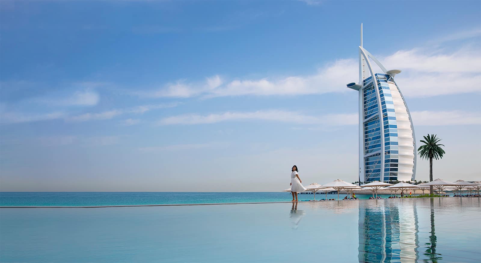 Woman standing infront of Burj Al Arab in Dubai